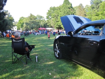 The owner sitting near his 2013 Chevrolet Camaro, on view in the 5th Annual Power In The Park Classic Car Show & 8th Annual Uncle Sam Jam at Power's Memorial Park in Troy,NY, Saturday, August 30, 2014. (c) Amy L. Modesti, 2014