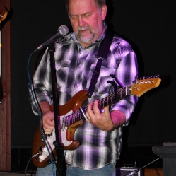 Slide guitarist/vocalist/lap steel player, Kevin Maul, playing the slide guitar at his first live The Coveralls concert held at the Dinosaur Bar-B-Que Restaurant in Troy, NY. Photo taken by Amy L. Modesti with Canon Rebel SL1 on Friday, January 30, 2015. (c): Amy Modesti, 2015