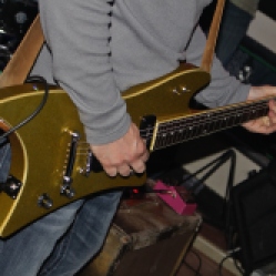 Close up of Matt Mirabile's gold guitar being played and used by the guitarist himself in his band's last performance set at Casey Finn's Pub and Grill LLC in Albany, NY. Photo taken by Amy L. Modesti on Friday, May 22, 2015 with her Canon Rebel SL1 Digital SLR Camera. (C): Amy Modesti, 2015