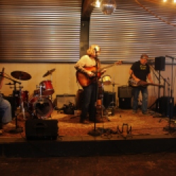 Dead2Me Band members from left-right: Tony Markellis (bass guitar), Kyle Esposito (acoustic guitar/vocals), Bob Resnick (drums), and Kevin Maul (steel guitar) performing at "Still:DQ2 for Dick Quinn" concert held at The Hangar in Troy, NY, Sunday, October 11, 2015. Series 4/5. Photo taken by Amy L. Modesti with her Canon Rebel SL1 Digital SLR Camera. (C): Amy Modesti, 2015