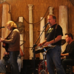 Dead2Me members from left-right: Kyle Esposito (acoustic guitar/vocals), Tony Markellis (bass guitar), Kevin Maul (steel guitar/vocals), and Bob Resnick (drums), performing at "Still: DQ 2 For Dick Quinn" concert held at The Hangar in Troy, NY, Sunday, October 11, 2015. Series 5/5. Photo taken by Amy L. Modesti with her Canon Rebel SL1 Digital SLR Camera. (C): Amy Modesti, 2015
