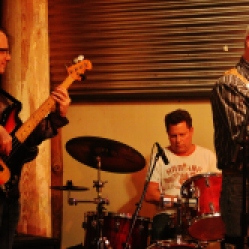 "The Coveralls" Featuring Kyle Esposito (bass guitar), Bob Resnick (drums), and Peter Bearup (electric guitar), performing at "Still: DQ 2 For Dick Quinn" concert held at The Hangar in Troy, NY, Sunday, October 11, 2015. Series 7/17. Photo taken by Amy L. Modesti with her Canon Rebel SL1 Digital SLR Camera. (C): Amy Modesti, 2015