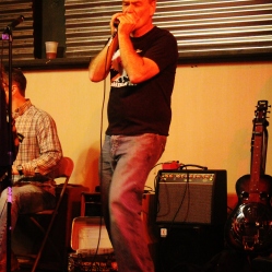 Ted Hennessey from the DoorNellies, playing the harmonica at the "Still: DQ 2 For Dick Quinn" concert held at The Hangar in Troy, NY, Sunday, October 11, 2015. Series 3/15. Photo taken by Amy L. Modesti with her Canon Rebel SL1 Digital SLR Camera. (C): Amy Modesti, 2015