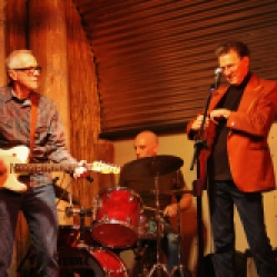 The "Tichy Boys" featuring John Tichy (guitar/vocals), drummer, Johnny Rabb (vocals), and Graham Tichy (guitar/vocals) performing at "Still: DQ 2 For Dick Quinn" concert held at The Hangar in Troy, NY, Sunday, October 11, 2015. Series 6/19. Photo taken by Amy L. Modesti with her Canon Rebel SL1 Digital SLR Camera. (C): Amy Modesti, 2015