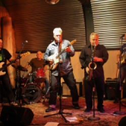 Mark Gamsjager (middle, guitar) from "The Lustre Kings" performing with Graham Tichy (vocals/guitar, far right" from "The Tichy Boys" and other local musicians at "Still: DQ 2 For Dick Quinn" concert held at The Hangar in Troy, NY, Sunday, October 11, 2015. Series 1/13. Photo taken by Amy L. Modesti with her Canon Rebel SL1 Digital SLR Camera. (C): Amy Modesti, 2015