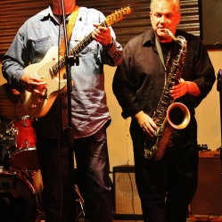 Mark Gamsjager (guitar/vocals, left) from "The Lustre Kings", performing with a local saxophonist at "Still: DQ 2 For Dick Quinn" concert held at The Hangar in Troy, NY, Sunday, October 11, 2015. Series 8/13. Photo taken by Amy L. Modesti with her Canon Rebel SL1 Digital SLR Camera. (C): Amy Modesti, 2015